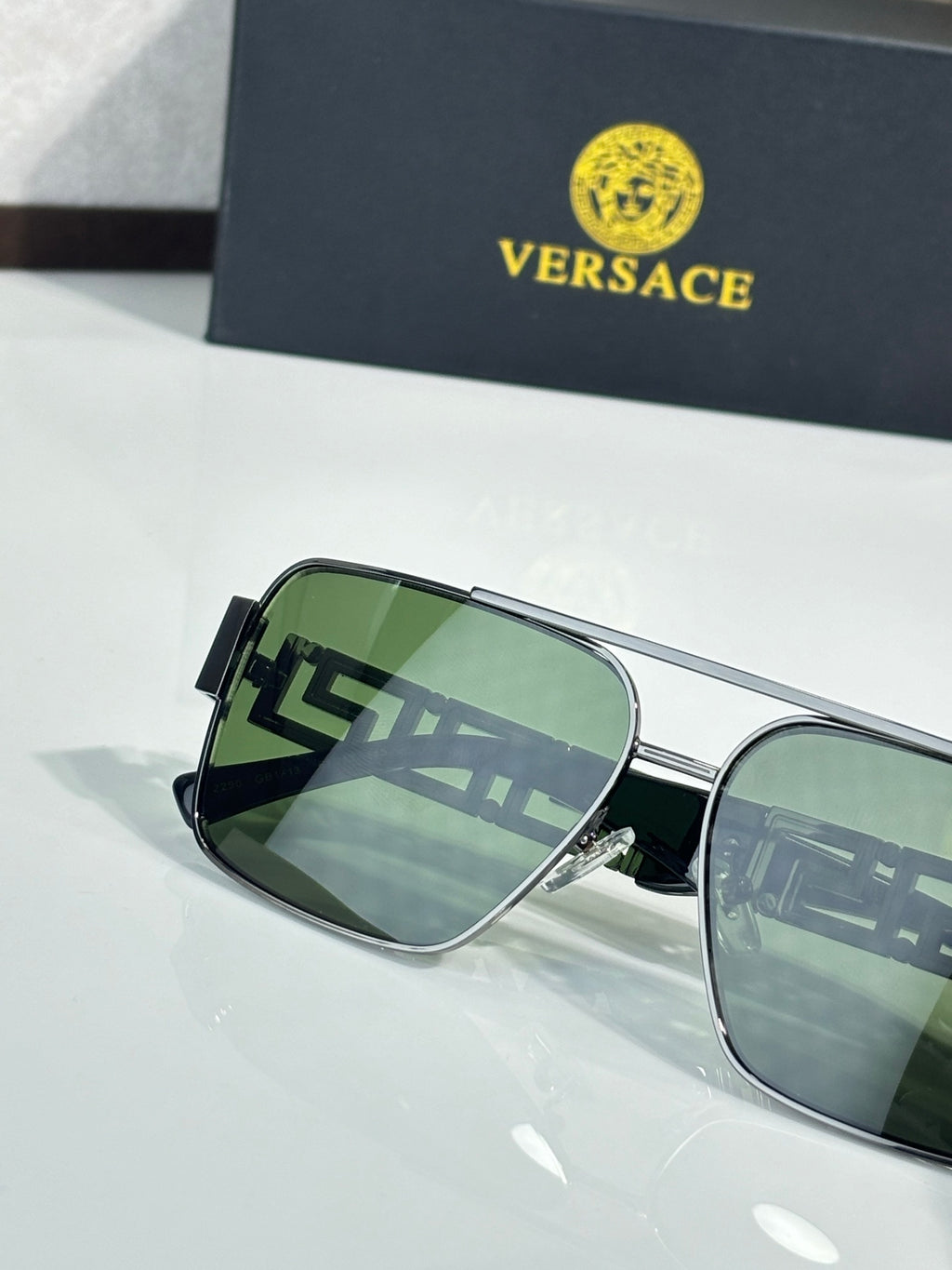Versace sunglasses with silver frames and green mirrored lenses