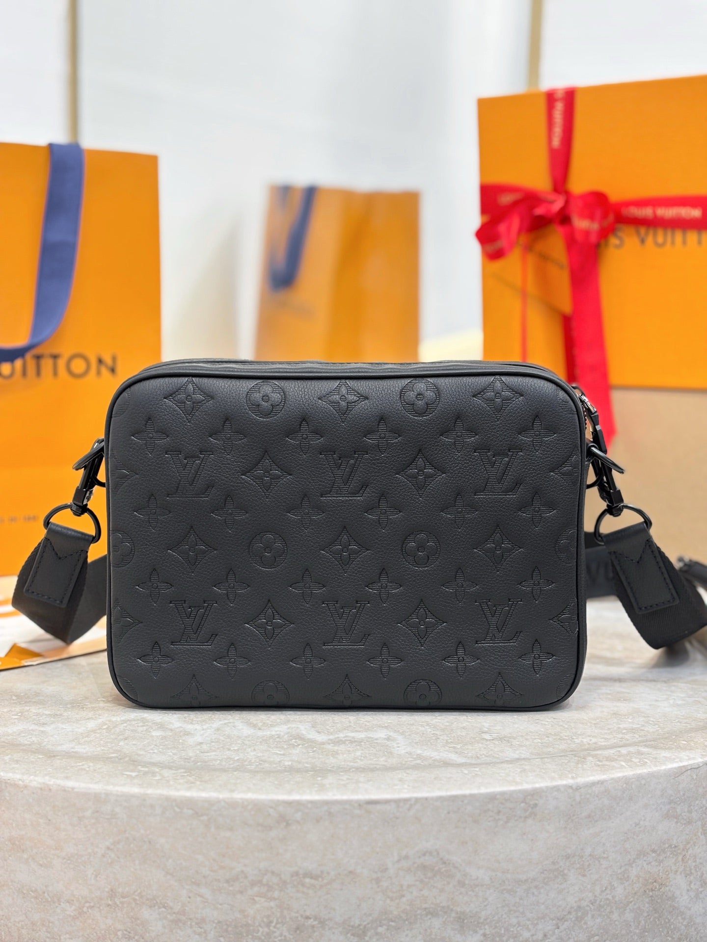 Louis Vuitton black monogram crossbody bag, front view with zip closure and side straps