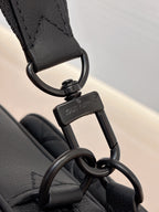 Louis Vuitton black monogram bag close-up of keyring clasp and attachment hardware