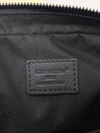 Louis Vuitton black monogram bag close-up of inner label under zipper opening