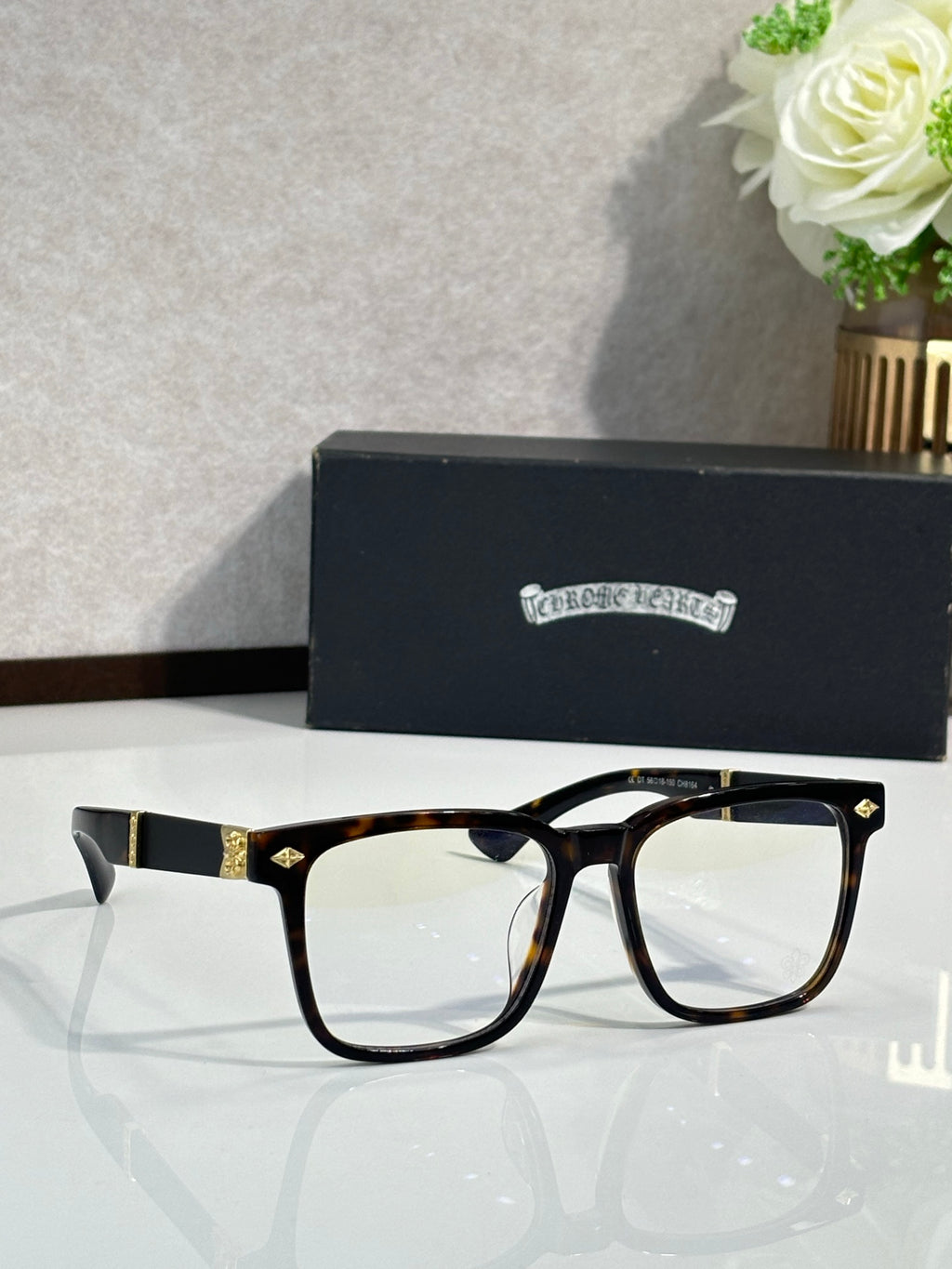 Tortoiseshell eyeglasses with clear lenses and gold-tone metal bridge