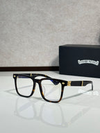 Black eyeglasses with blue-tinted lenses, gold-tone front trim, and clear arms