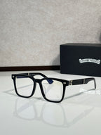 Black eyeglasses with blue-tinted lenses and gold-tone hinge details