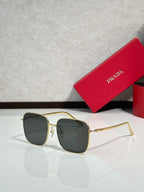 Prada sunglasses with gold frame and dark gradient lenses, rectangular aviator style