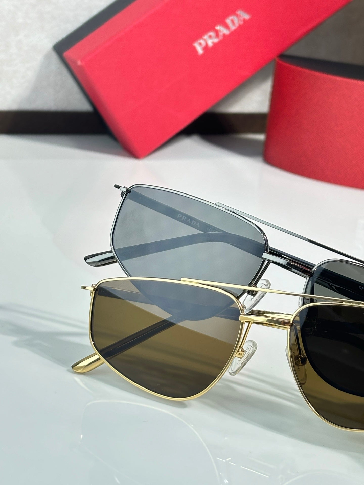 Prada aviator sunglasses close-up, gold and silver frames with tinted lenses