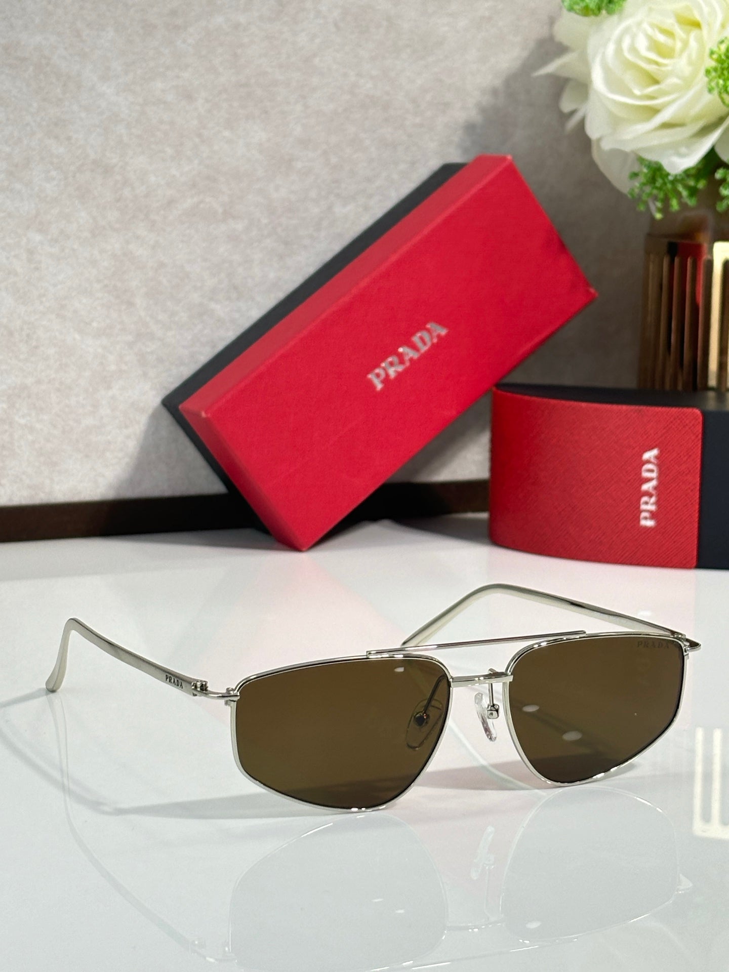 Prada aviator sunglasses with gold frame and brown tinted lenses