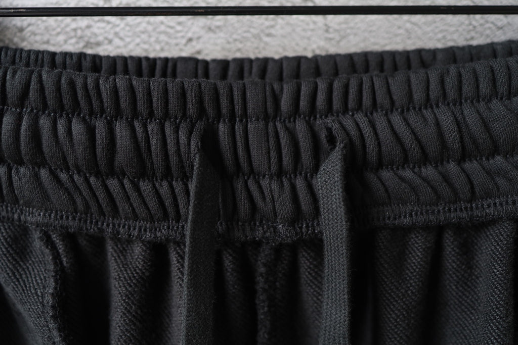 Balenciaga black shorts waistband close-up with textured elastic stitching