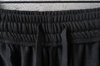 Balenciaga black shorts waistband close-up with textured elastic stitching