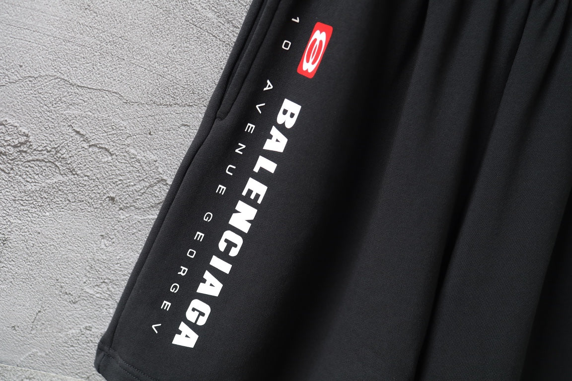 Balenciaga vertical logo text and icon on black pants