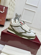 White and olive low-top sneakers, lace-up, with red and green stripe detail