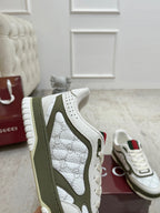 White and olive sneaker close-up side profile with textured logo panel