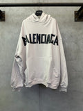 White long-sleeve hoodie with large black Balenciaga graphic on the chest
