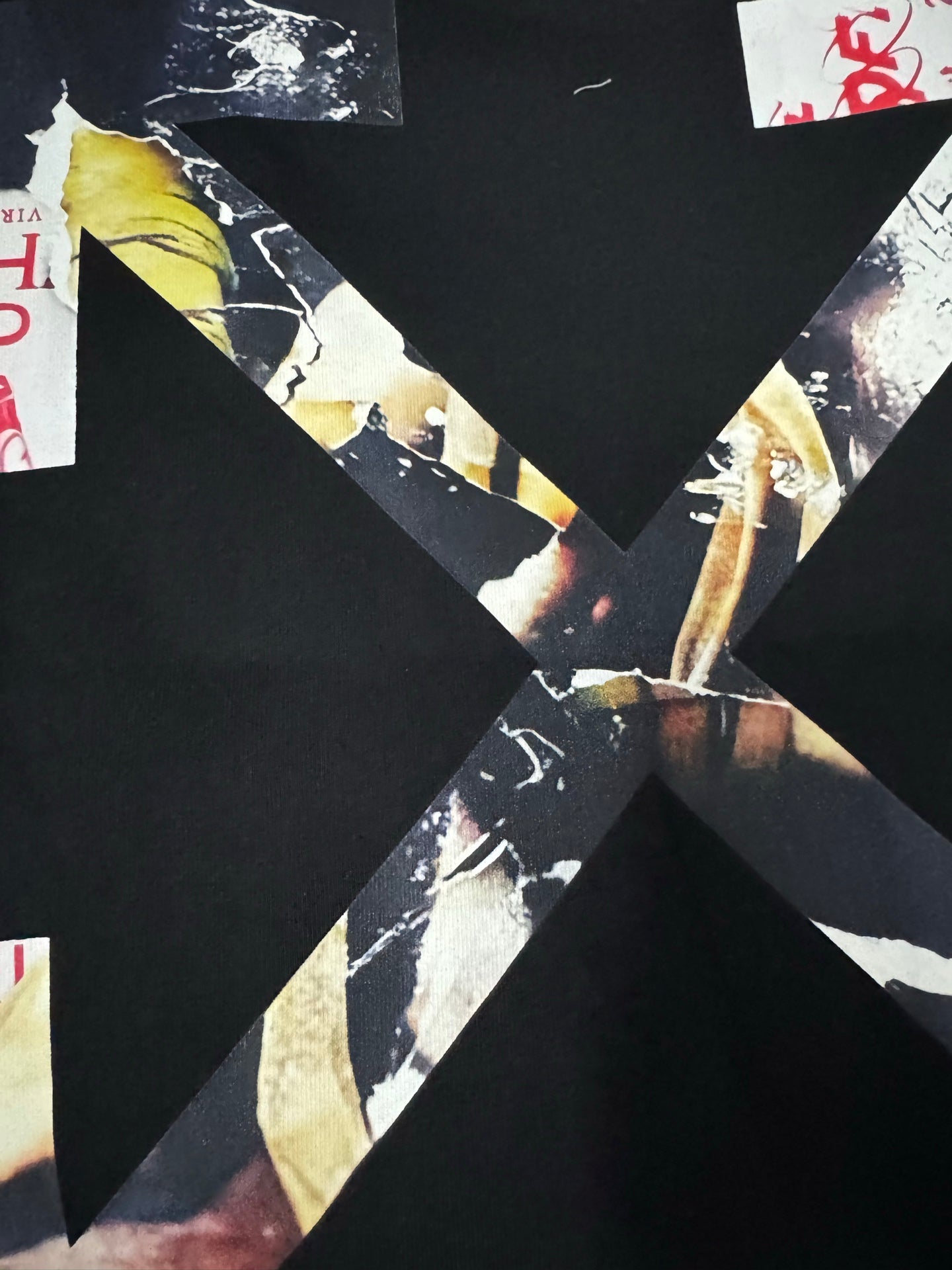 Black T-shirt close-up of back graphic with diagonal collage strips