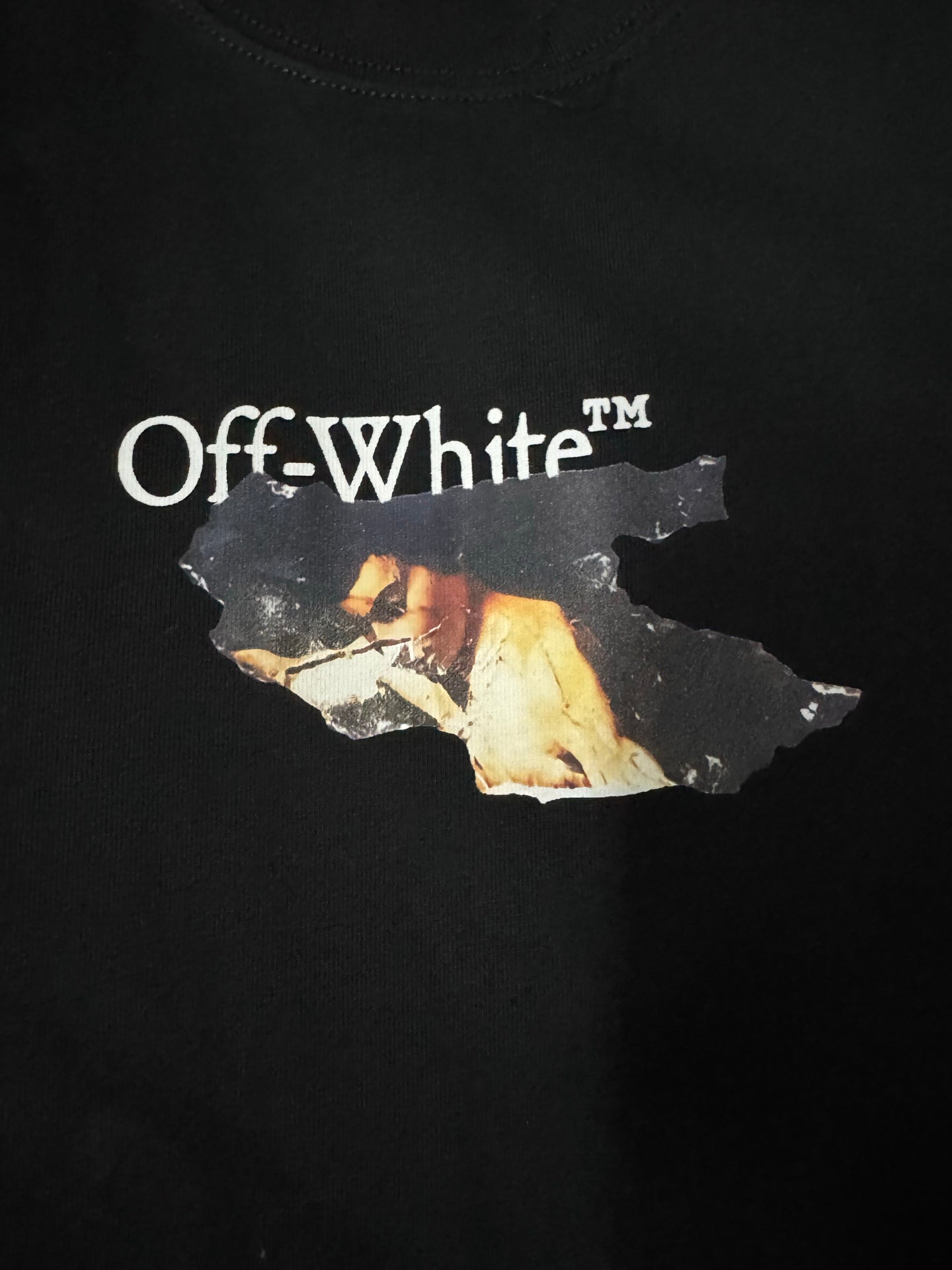 Black T-shirt close-up of large Off-White logo and photo-collage graphic