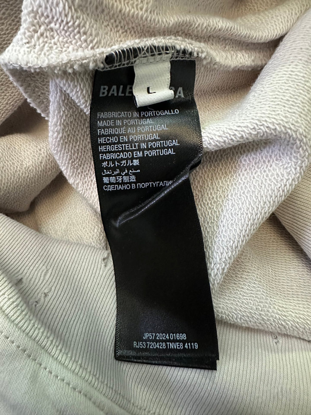 White hoodie interior neck label with text and barcode from Balenciaga
