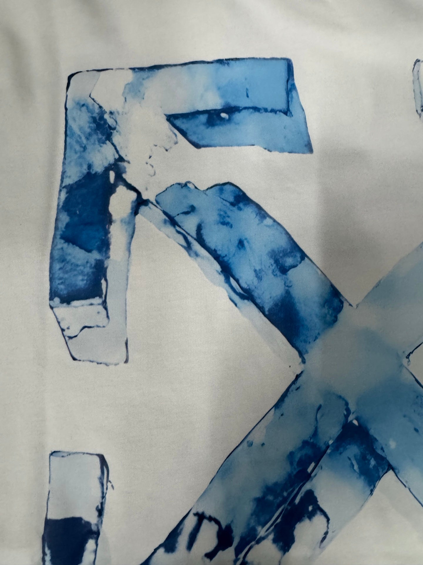 Off-White T-shirt close-up of blue “X” logo graphic details