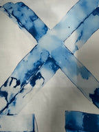 Off-White T-shirt close-up of blue “X” logo graphic across the fabric