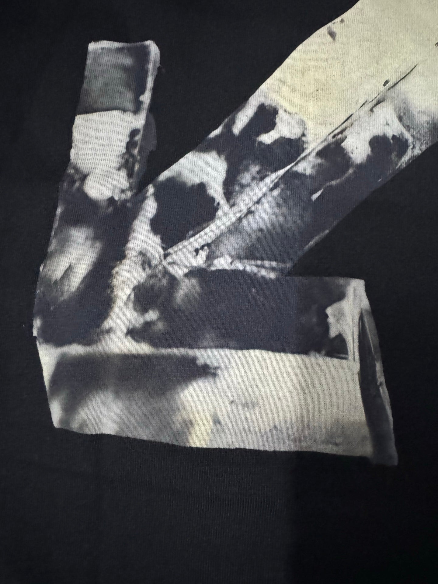 Black T-shirt close view: off-white Off-White X graphic at bottom