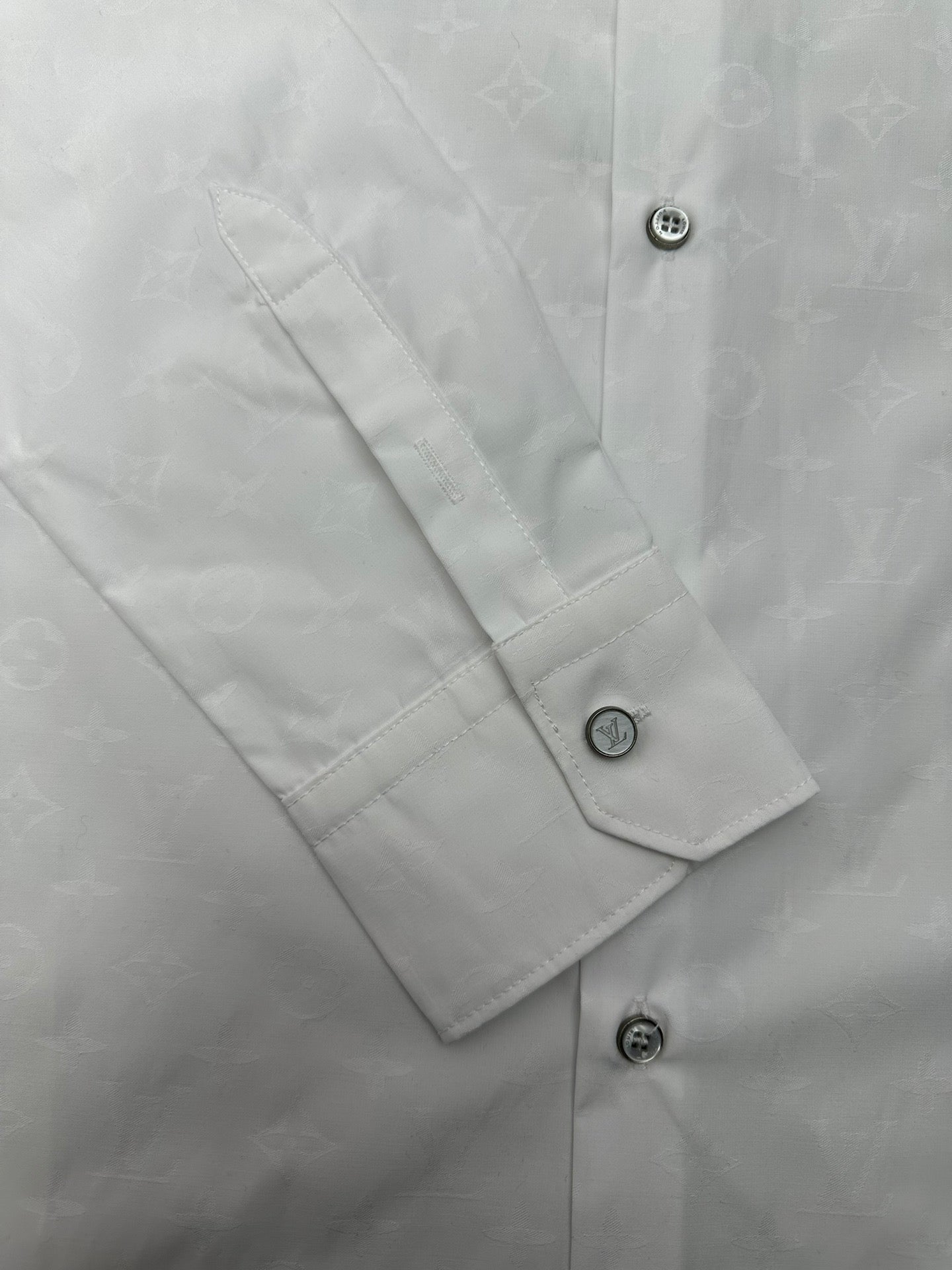 Louis Vuitton white shirt cuff and sleeve placket with round buttons and visible stitching