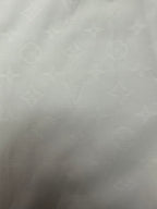 Louis Vuitton white shirt fabric panel with subtle monogram pattern texture