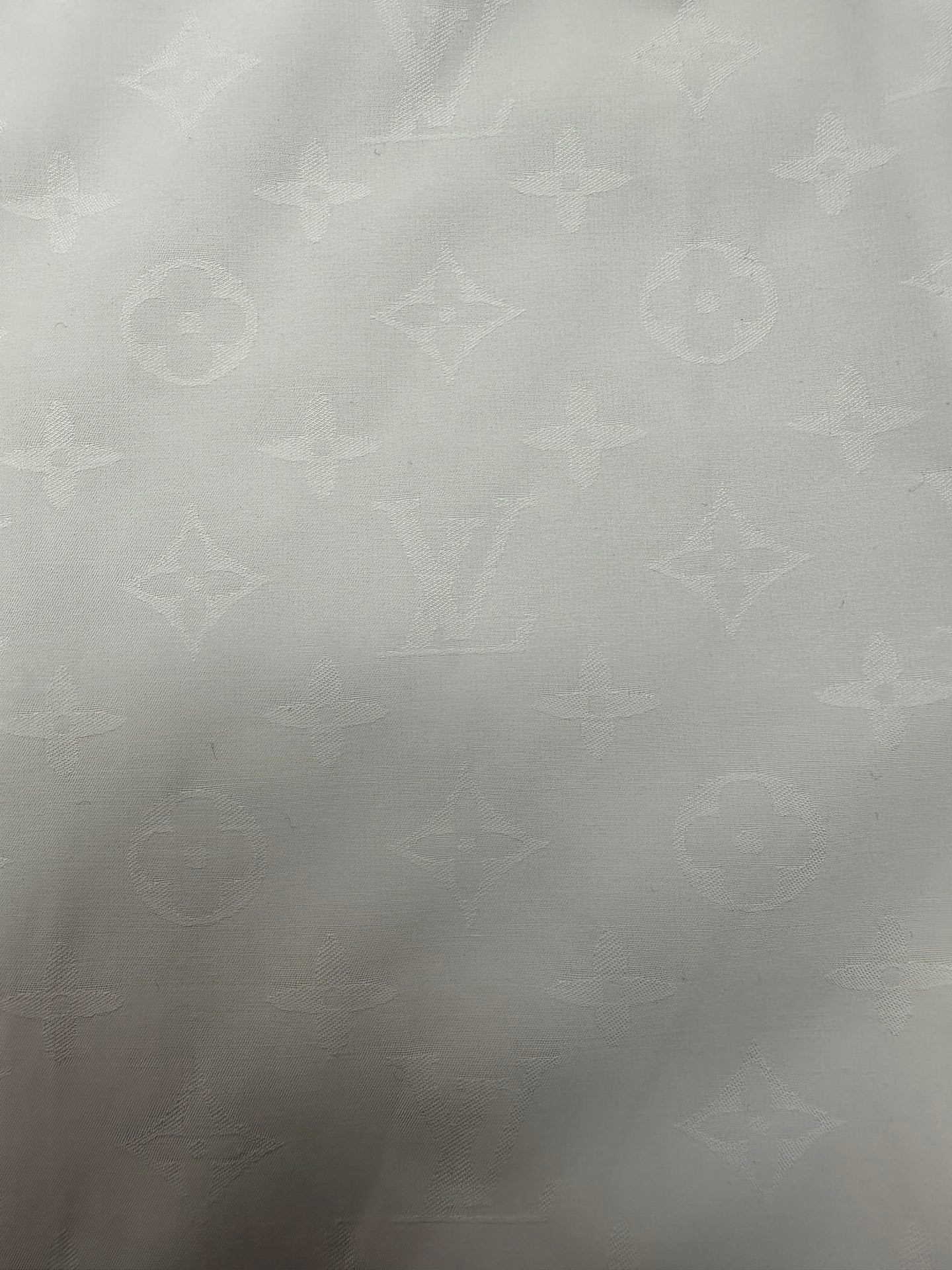 Louis Vuitton white shirt fabric panel with subtle monogram pattern texture
