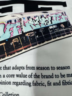 Off-White white T-shirt with graffiti band graphic and partial 'Mens Collection' text