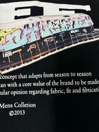 Black T-shirt close-up with bus artwork and “Mens Collection ©2013” text