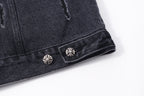 Dark denim jacket hem with decorative snap stud buttons and embroidered motifs