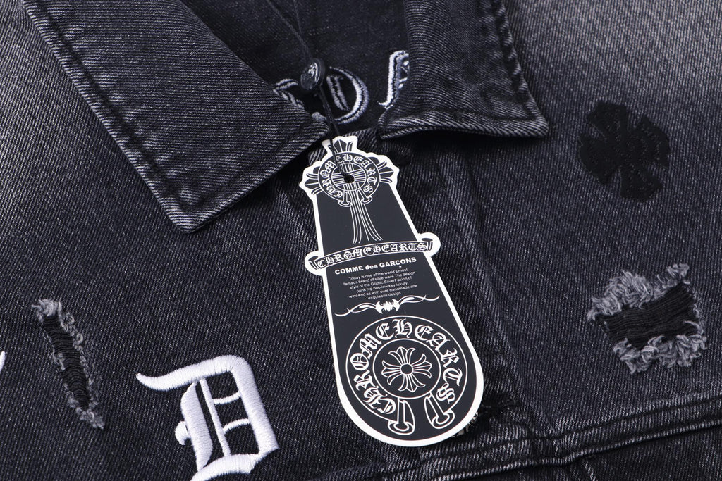 Dark denim jacket front collar with engraved emblem patch and small embroidery