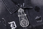 Dark denim jacket front collar with engraved emblem patch and small embroidery