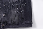 Dark denim jacket chest detail with embroidered cross and stitched panels