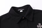 Black shirt jacket with pointed collar, button placket, and rhinestone logo detail