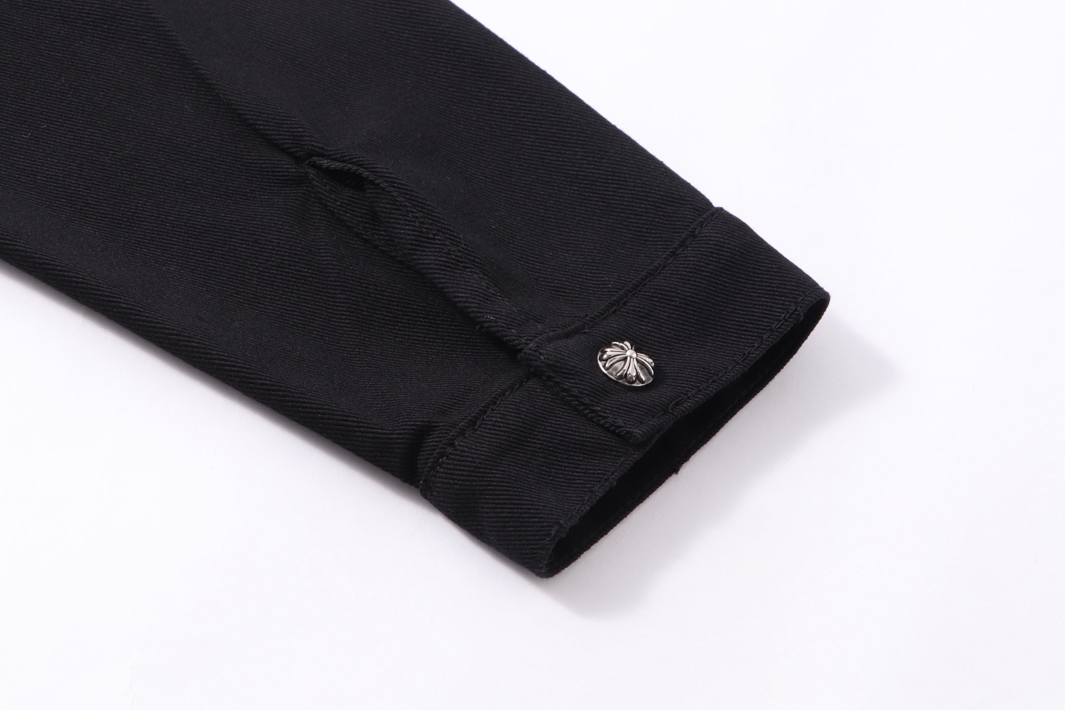 Black long-sleeve shirt jacket cuff with metallic button