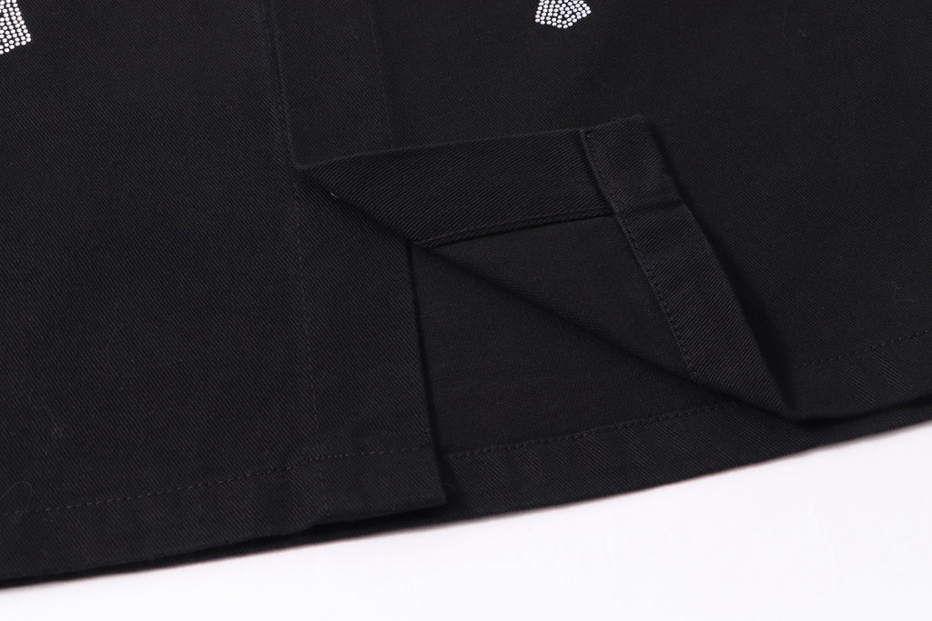 Black button-up shirt jacket hem with angled seam detail