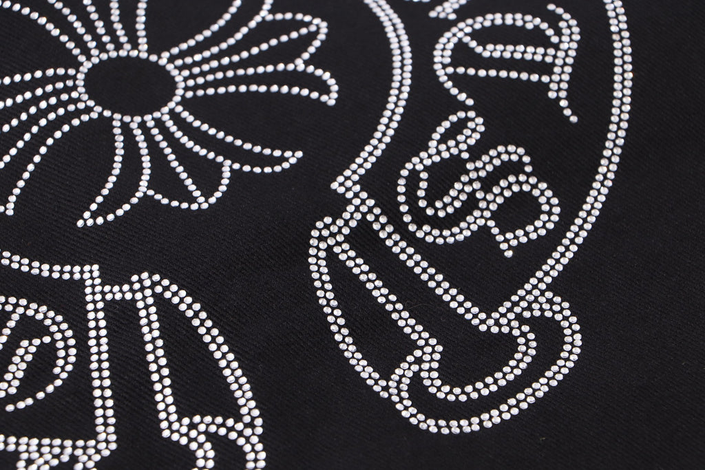 Black fabric with white rhinestone swirl and star cross decoration