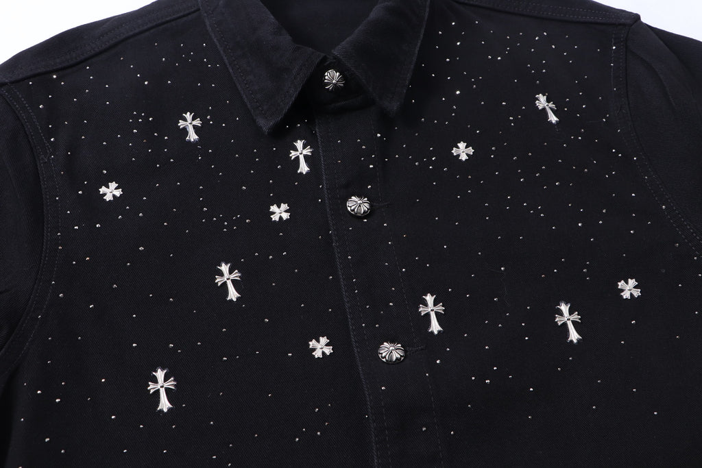 Black shirt front close-up with white cross motifs and button placket.