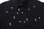 Black shirt front close-up with white cross motifs and button placket.
