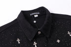 Black shirt neckline close-up with collar, front buttons, and white motif accents.