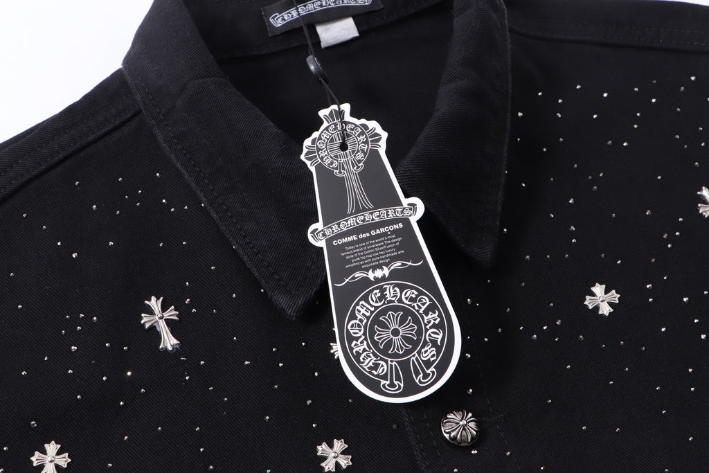 Black shirt collar with white emblem patch and button placket detail.