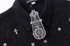 Black shirt collar with white emblem patch and button placket detail.