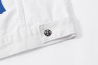 White jacket hem with small metal button and reinforced fabric stitching