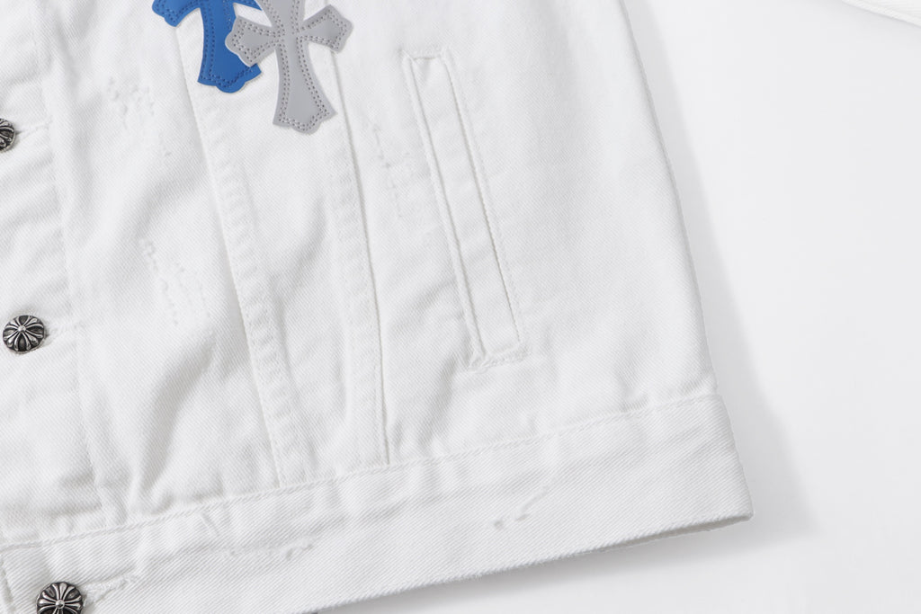 White denim jacket hem with stitched pockets and small metal button detail