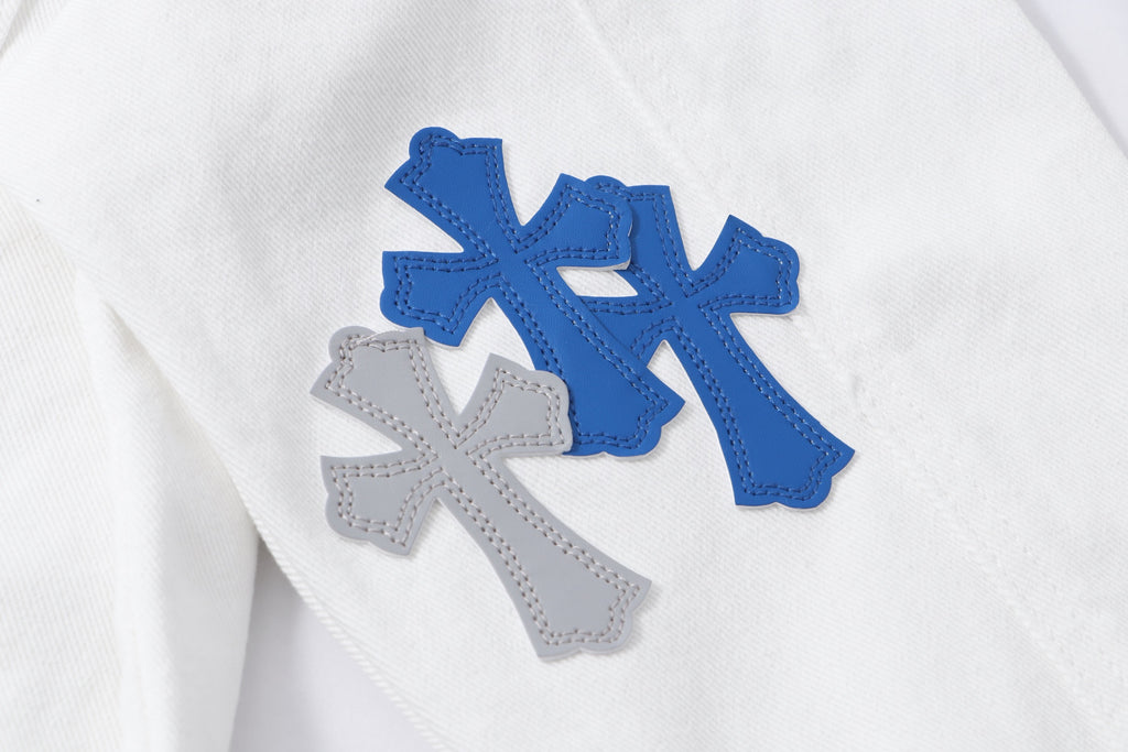 Close-up of white jacket front with layered blue and gray cross patches