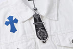 White denim jacket with blue cross applique and hanging black brand tag at collar