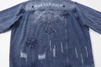 Blue denim jacket back with cross outline and small star and floral patches