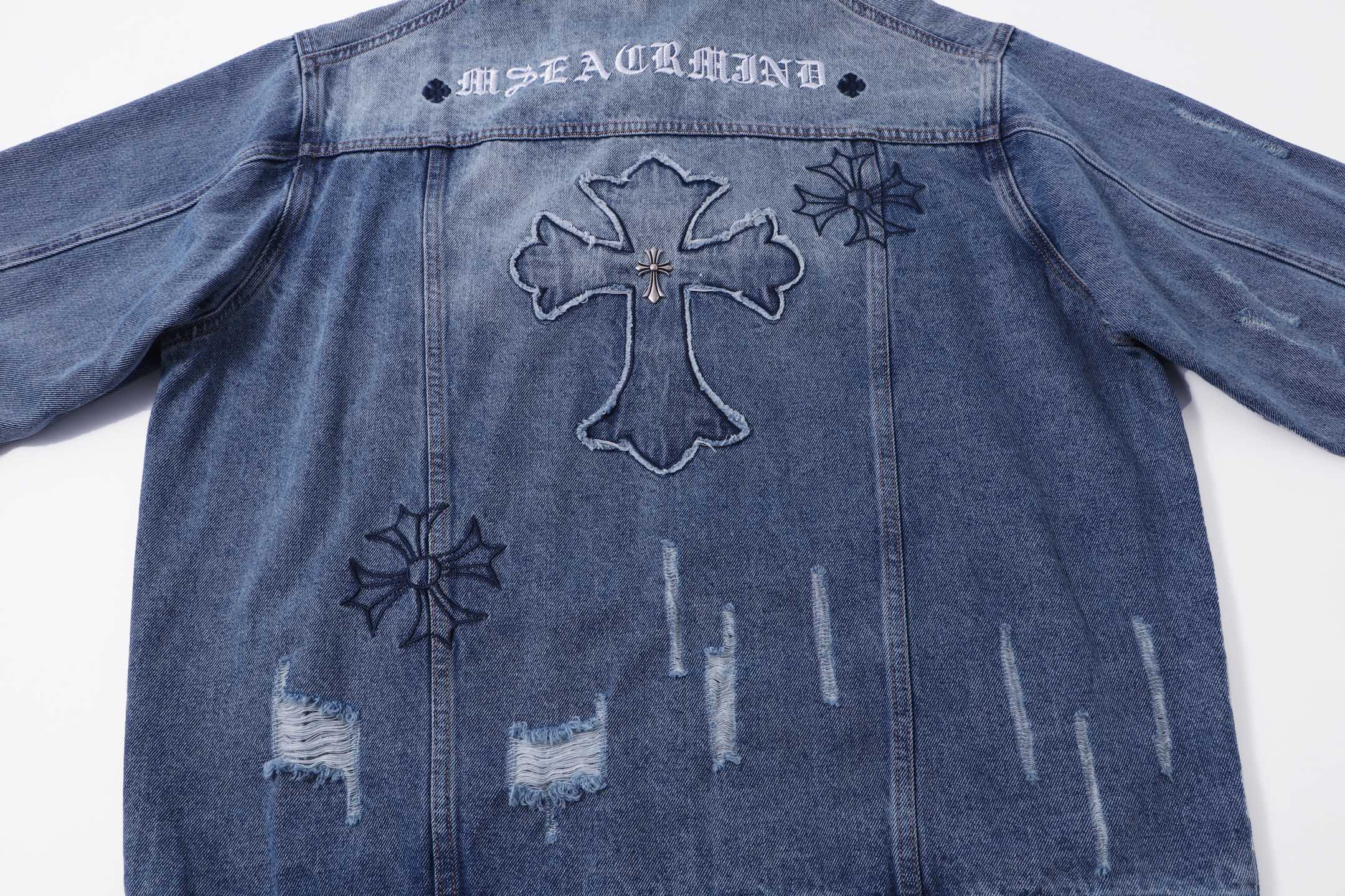 Blue denim jacket back with cross outline and small star and floral patches
