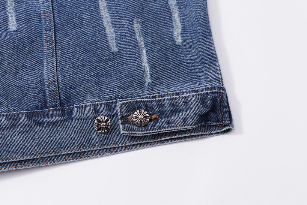 Blue denim jacket hem with decorative metal buttons and stitched border