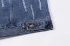 Blue denim jacket hem with decorative metal buttons and stitched border