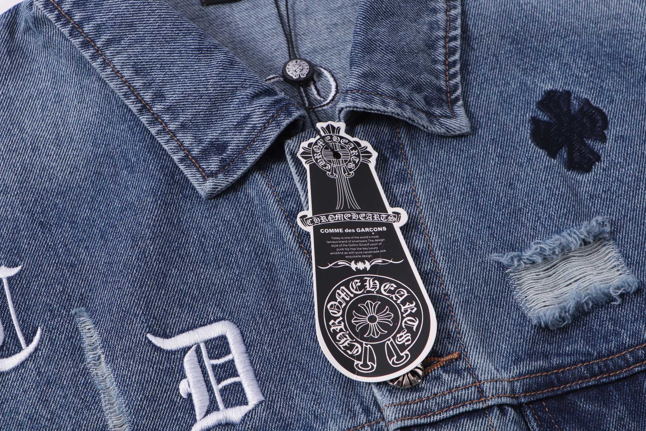 Blue denim jacket close-up of button placket and crest patch