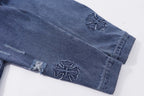 Blue denim jacket sleeves with embroidered cross appliques and distressed cuffs